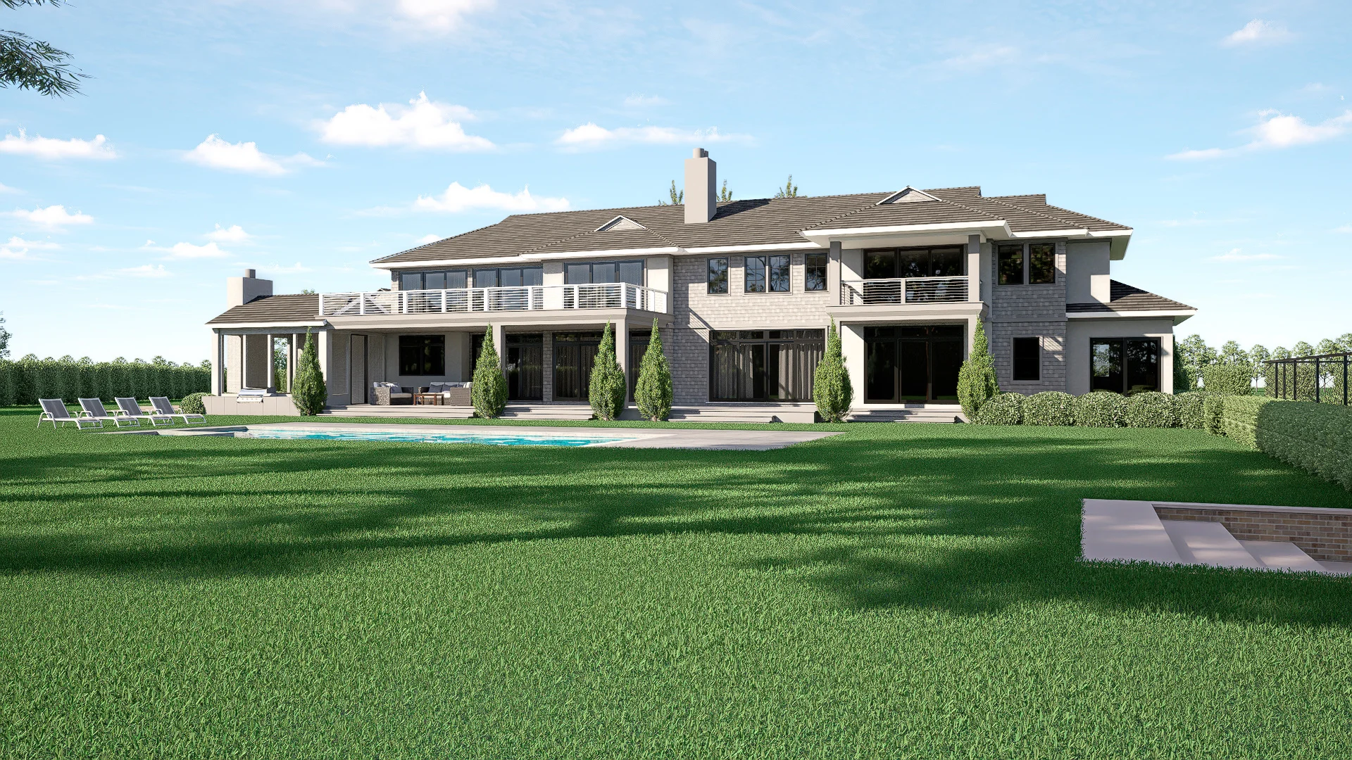 A large modern two-story custom luxury home with gray siding, multiple balconies, and large windows, surrounded by a spacious green lawn with a swimming pool and several lounge chairs in the backyard—perfect for modern real estate lovers.