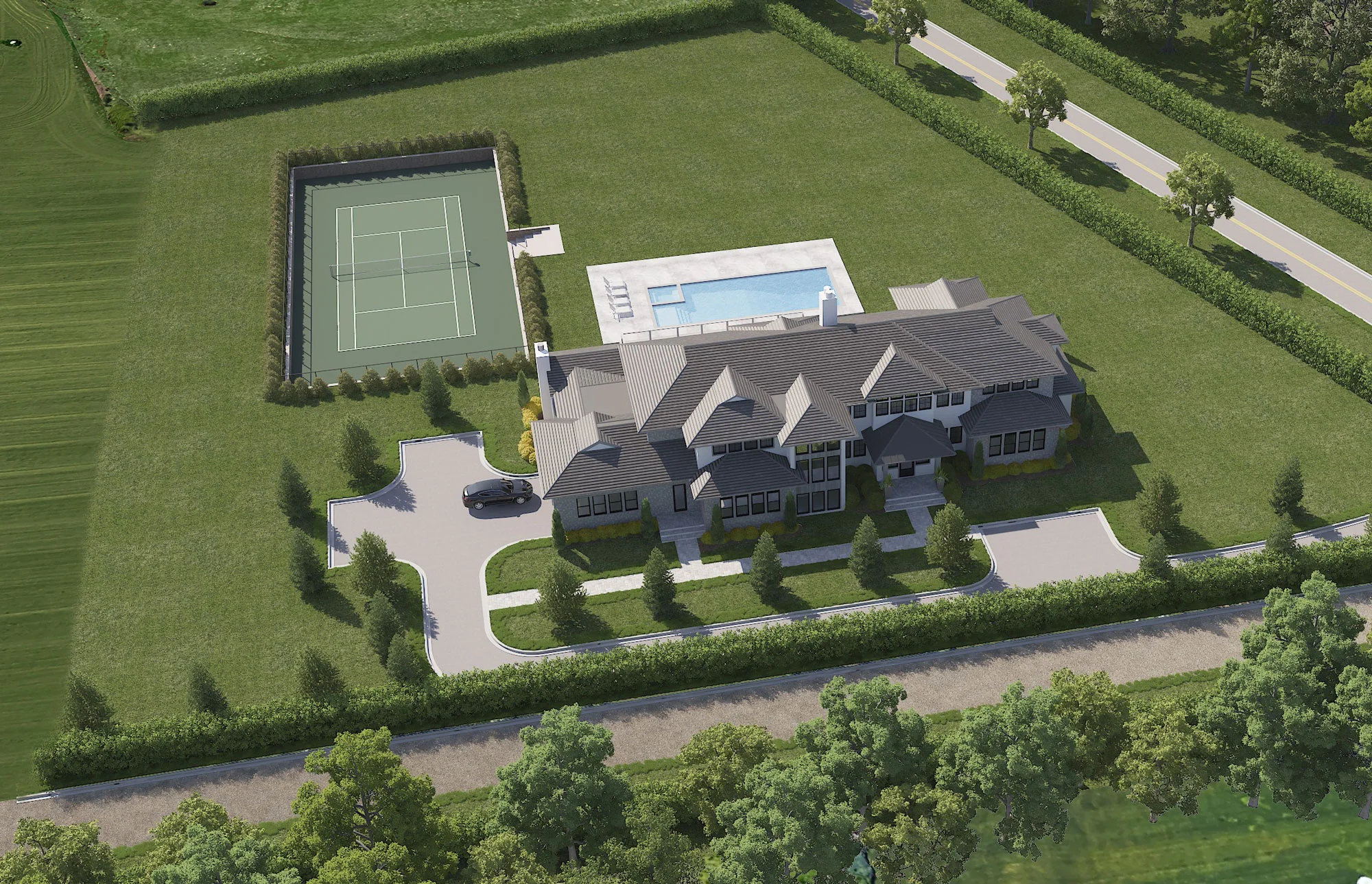 Aerial view of a large, two-story house with a circular driveway, surrounded by green lawns. Behind the house are a rectangular swimming pool with lounge chairs and a fenced tennis court. Trees border the property.